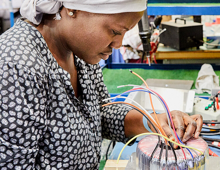 A D-BOX employee works on a new haptic technology part
