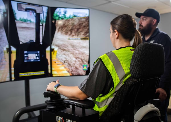 A woman trains on a CAT motion simulator